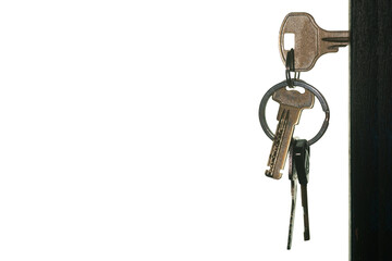 Set of keys with keyring in the door keyhole isolated on white background