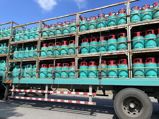A photo of a truck loaded with gas steel containers in Paka, oil and gas processing station - obrazy, fototapety, plakaty
