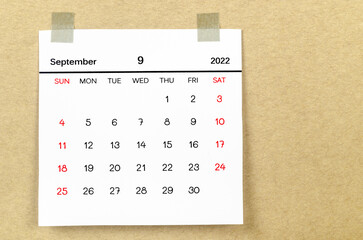 September 2022 calendar on brown background.