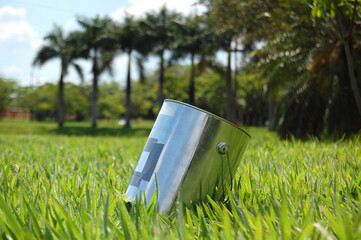 Paint can pinhole camera on the lawn of the park. photographing outdoors. Old photography. pin...