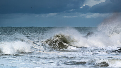 Storm waves breaking over rocks
