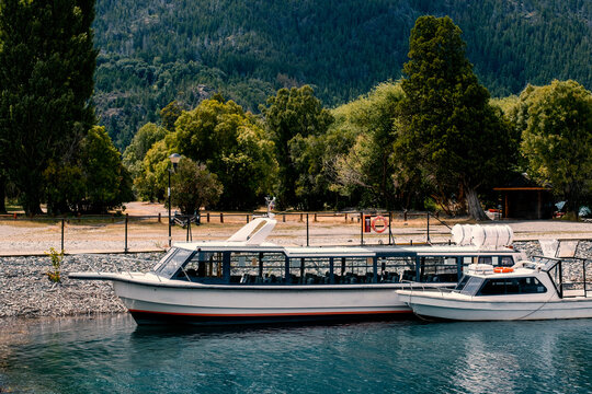 Boat in the pier lake. Ferry, ferryboat, gondola, taxi, water taxi, banker, coble, dragger, gillnetter, hooker, lugger.