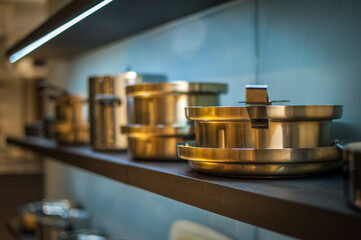 shining copper pots and pans on open shelves