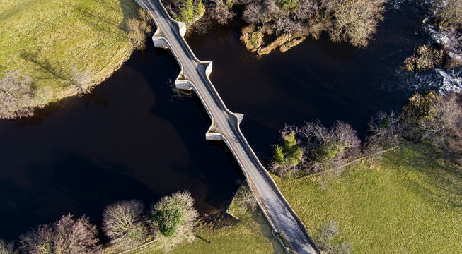an aerial view of an ancient bridge across a river in North Yorkshire