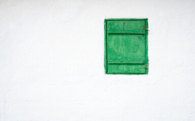  One green windows on a white wall - Powered by Adobe