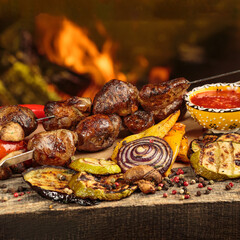 Shashlik or shish kebab preparing on barbecue grill over hot charcoal. Grilled pieces of pork meat on metal skewers. Square image