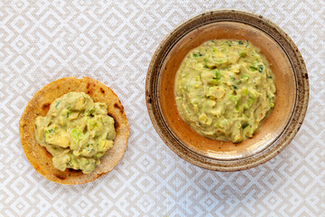 Avocado with roasted tomatillo salsa, tahini and greek yogurt .corn roti