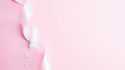 Menstrual tampon feminine hygiene. Pink ribbon with menstrual tampon on pink background. Menstruation feminine period. Sanitary hygiene concept. Medical healthcare gynecological banner.