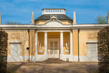 Great front view of the Bath House, a building in the style of an Italian villa built by Pigage for Elector Carl Theodor in the famous garden of the Schwetzingen Palace in Germany. - obrazy, fototapety, plakaty