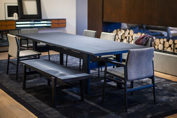 black wooden dining table with modern chairs and a bench
