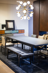 black wooden dining table with modern chairs and a bench