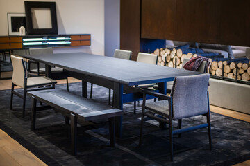 black wooden dining table with modern chairs and a bench