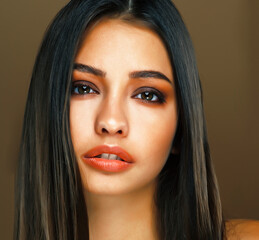 Fototapeta premium cute happy young indian woman in studio closeup smiling on brown background, fashion beauty lifestyle people concept