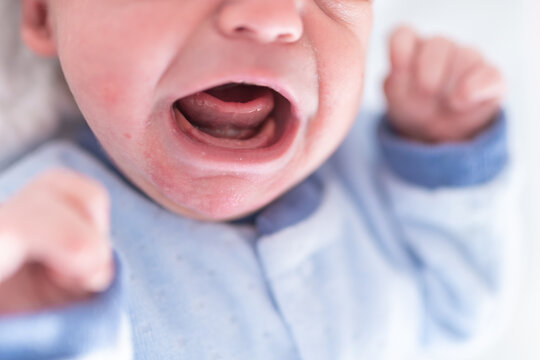 Portrait of a crying newborn. discomfort of the baby with colic in the belly. concept health care and care of the newborn, pediatrics