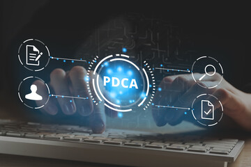 Concept PDCA or Plan Do Check Act. Management of processes. Person working at a computer