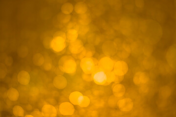 yellow glitter vintage lights background. White bokeh on yellow background.