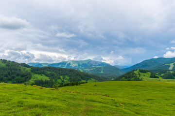 A picturesque landscape view of the French Alps mountains on a cloudy summer day (Valberg, Alpes-Maritimes, France)