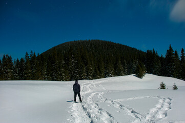 tourist on the background of winter night landscape, frosty night