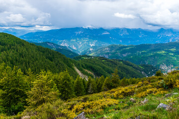 A picturesque landscape view of the French Alps mountains on a cloudy summer day (Valberg, Alpes-Maritimes, France)