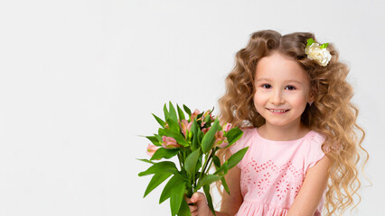 Obraz na płótnie Canvas portrait little beautiful cute curls blonde girl with bouquet. child with astromeria flowers in hands. spring holiday kid concept, international women's day, March 8, mother's day. banner