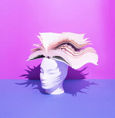 Human head with open book on blue and purple background. Surreal, education, study and knowledge...