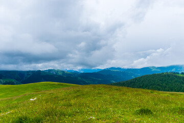 A picturesque landscape view of the French Alps mountains on a cloudy summer day (Valberg, Alpes-Maritimes, France)