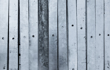 Galvanized metal plates with traces of corrosion, stacked in a stack, close-up.