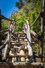 traditional bamboo bridge for crossing river at forest at morning from flat angle
