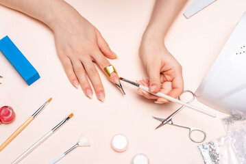 a girl doing a manicure at home, hands close-up. the view from the top