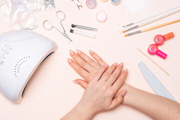 girl's hands on the background of manicure accessories. close up