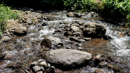 East Java, Indonesia - February 10, 2022 : A nature view of the rocks in the river.