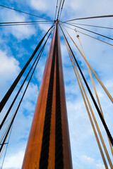 Mast of a sailing yacht without a sail. View from below.