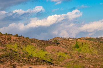 mountain covered with yellow grass and bright blue sky at afternoon from flat angle