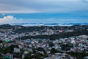 Fototapeta na wymiar downtown city view with dramatic cloudy sky at evening from mountain top
