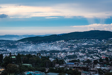 downtown city view with dramatic cloudy sky at evening from mountain top