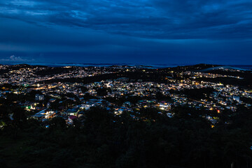 downtown city night view with lighting and dramatic cloudy sky at evening from mountain top