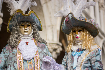 period costumes in front of the basilica of San Marco for the Venice Carnival
