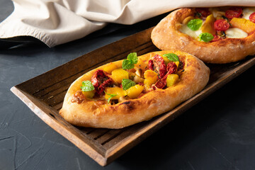 A pie with vegetables on a dark background. Breakfast is an appetizer.