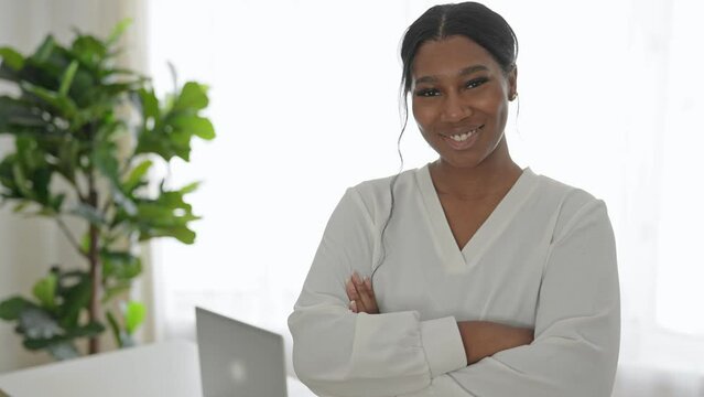 young African American businesswoman working at laptop at home office