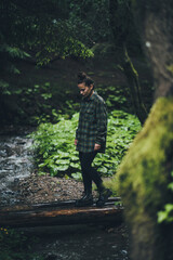 Girl wearing a flannel shirt in the woods