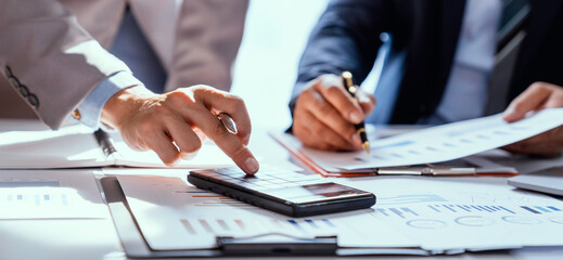 Business team working on new startup projects. Discuss the analysis of charts and graphs showing investment performance reports. and profit accounting and finance business ideas