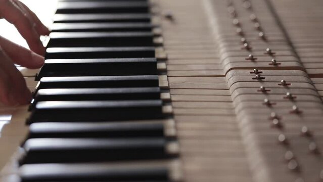 Woman play on open vintage wooden piano