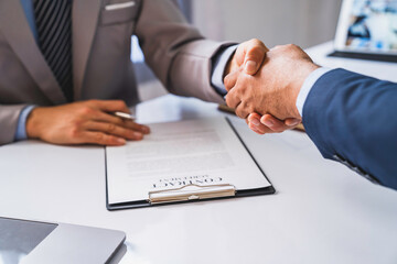 Employer interviewing for a job or head of HR is shaking the hand of male job applicant greeting with the successful interview, HR handshake man candidate congratulating with employment, welcome work