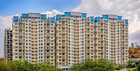 Image of colorful tall building ready construction with clear blue sky background in Pune, Maharashtra.