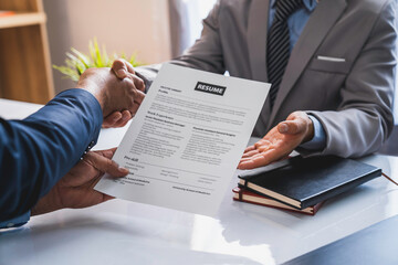 Employer interviewing for a job or head of HR is shaking the hand of male job applicant greeting with the successful interview, HR handshake man candidate congratulating with employment, welcome work