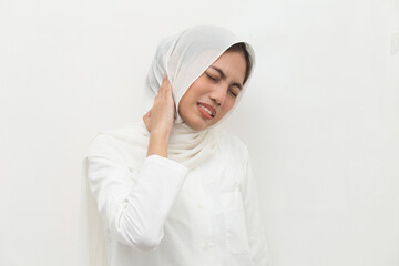 young asian muslim woman with neck and shoulder pain and injury. medical concept
