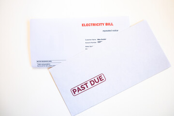 Electricity bill and post envelope marked urgent, overdue, past due as price rise concept