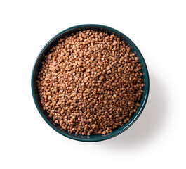 Raw organic buckwheat groats in a blue ceramic bowl isolated on a white background. Roasted buckwheat grains for healthy vegetarian food. Gluten free diet and dietary fiber concepts.