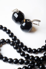 jewels  with black semipreciouse beads  with natural gagat  stone around white background. macro shot . top view