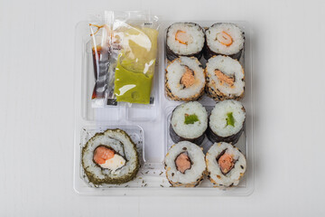 Prepared Japanese sushi in a bowl on a white background.